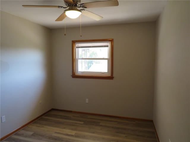 spare room with wood-type flooring and ceiling fan