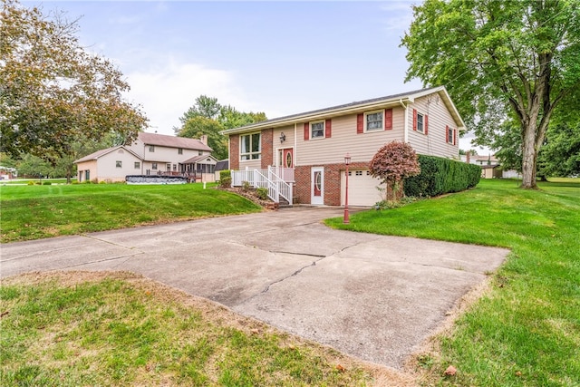 bi-level home featuring a front lawn and a garage