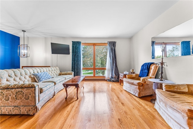 living room featuring hardwood / wood-style flooring, a notable chandelier, and a wealth of natural light