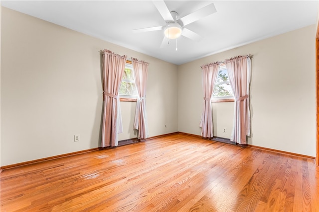 unfurnished room with ceiling fan, light wood-type flooring, and a healthy amount of sunlight