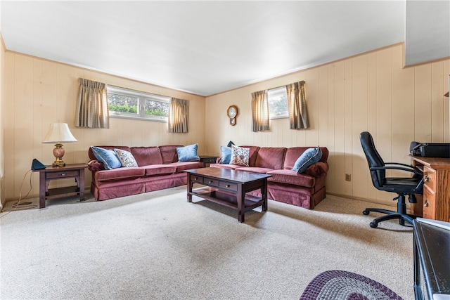 carpeted living room with wooden walls