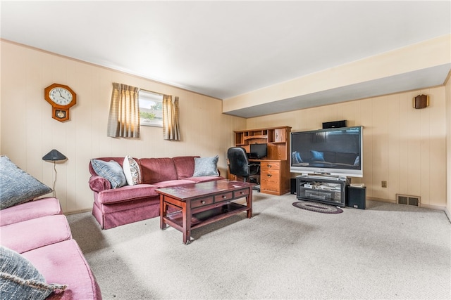 living room featuring wood walls and carpet flooring