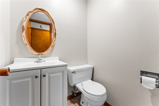 bathroom featuring tile patterned flooring, vanity, and toilet