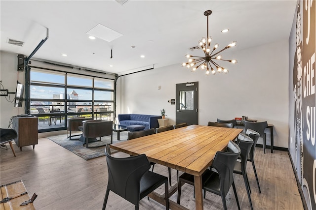 dining space featuring a notable chandelier and hardwood / wood-style floors