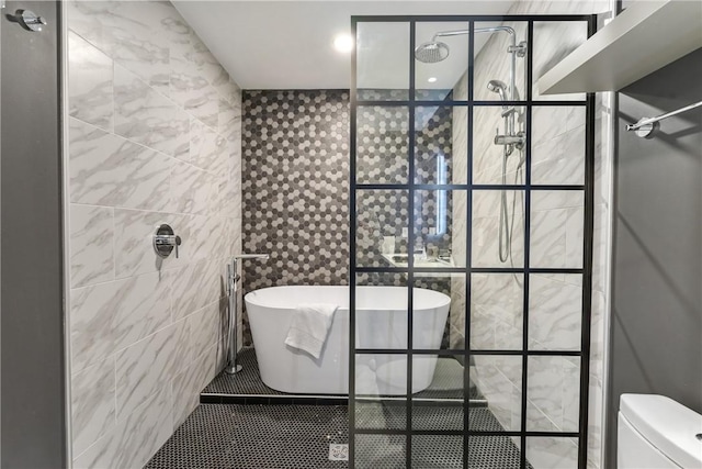 full bath featuring tiled shower, a freestanding tub, tile walls, and tile patterned floors