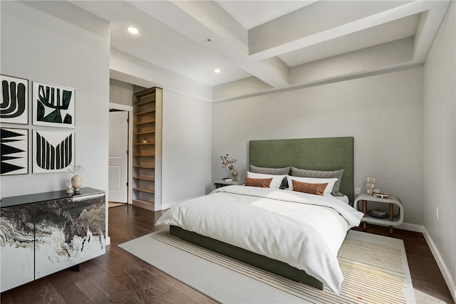 bedroom featuring dark wood-type flooring and beam ceiling