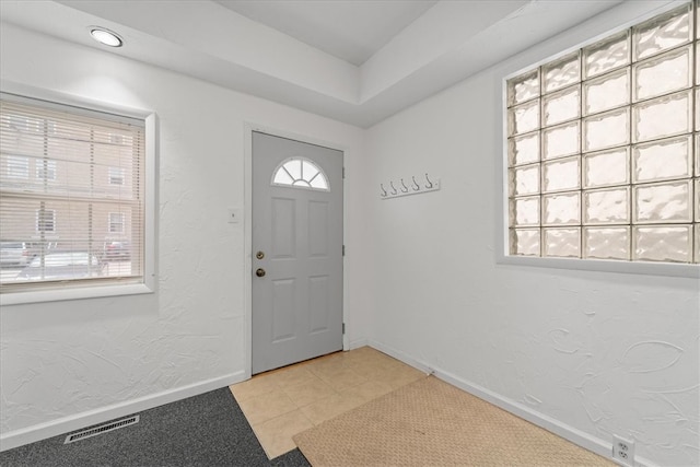 entryway with light tile patterned flooring