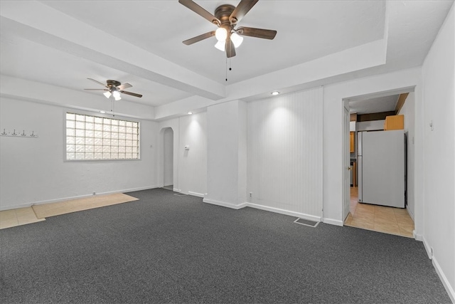 spare room featuring ceiling fan and carpet flooring