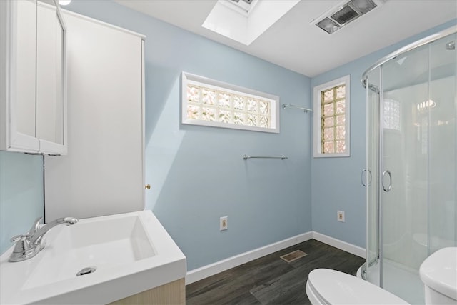 bathroom with walk in shower, vanity, and toilet