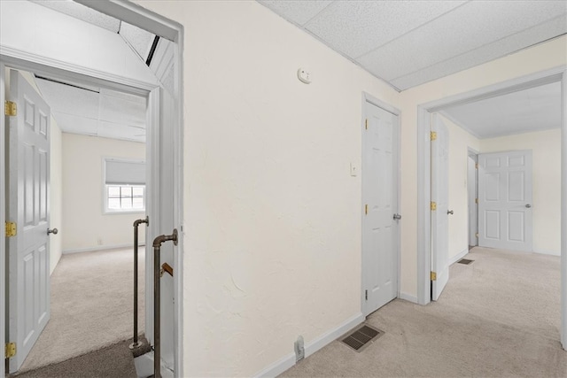 hallway with light colored carpet