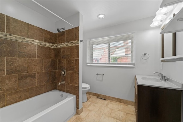 full bathroom with tiled shower / bath combo, vanity, and toilet