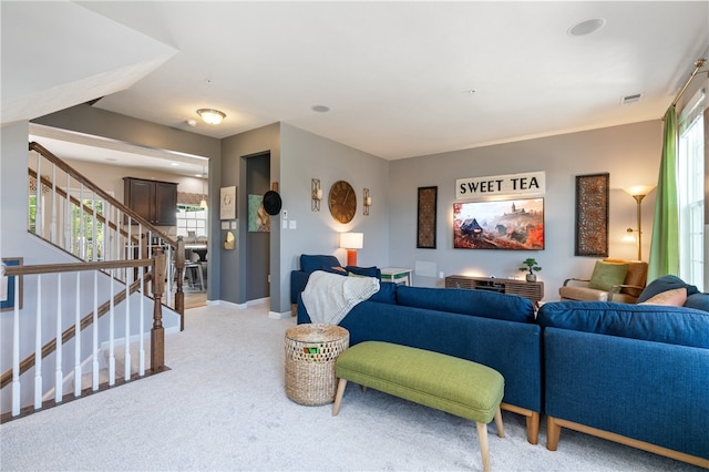 carpeted living room featuring plenty of natural light