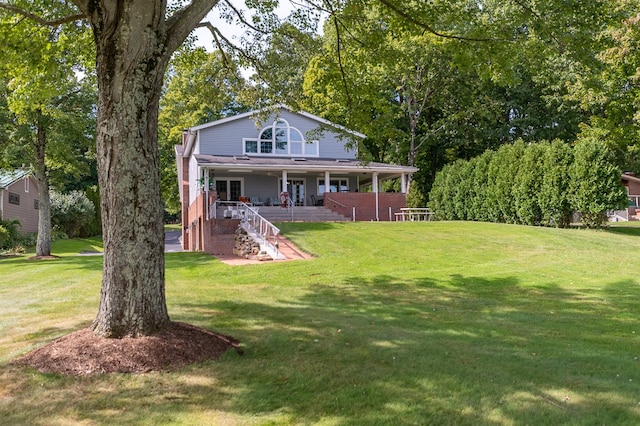 rear view of property with a yard and a porch