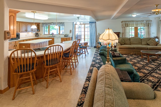 interior space featuring light tile patterned flooring, sink, and ceiling fan