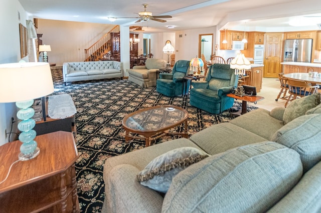 living room with carpet flooring and ceiling fan