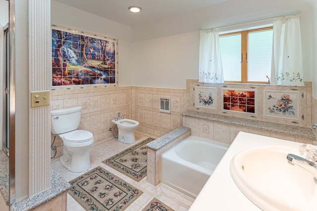 bathroom featuring a bathtub, sink, a bidet, tile patterned floors, and toilet