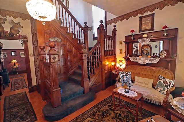 stairs with an inviting chandelier