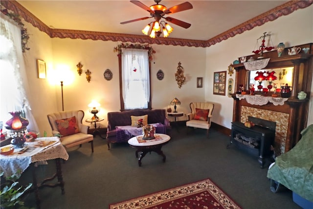 living room featuring ceiling fan, carpet flooring, and a wood stove