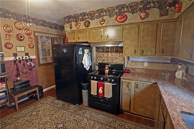 kitchen with dark wood-type flooring, light stone countertops, and black appliances