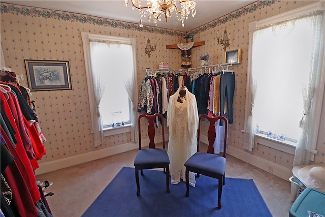 workout area featuring a wealth of natural light, a chandelier, and carpet