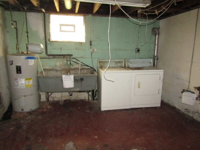 basement featuring washer and clothes dryer, water heater, and sink