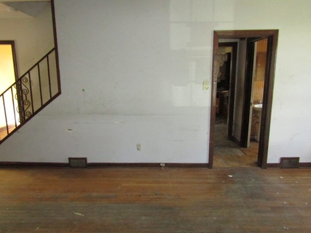 empty room featuring dark wood-type flooring