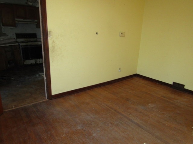 empty room featuring dark hardwood / wood-style flooring