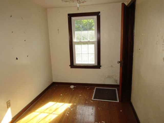 empty room with dark hardwood / wood-style floors