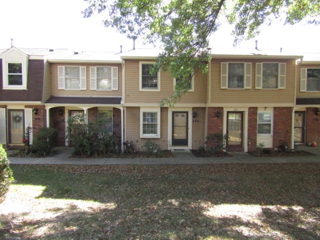 townhome / multi-family property with brick siding