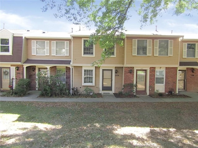 view of property featuring brick siding