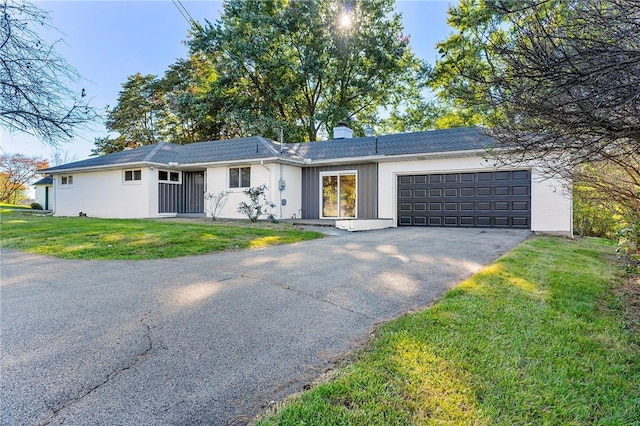 ranch-style home with a front yard and a garage