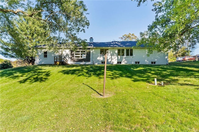 back of house featuring a yard