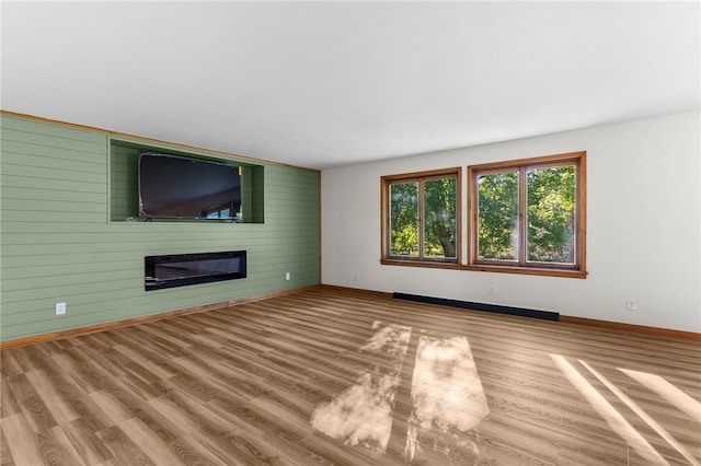 unfurnished living room featuring a fireplace and wood-type flooring