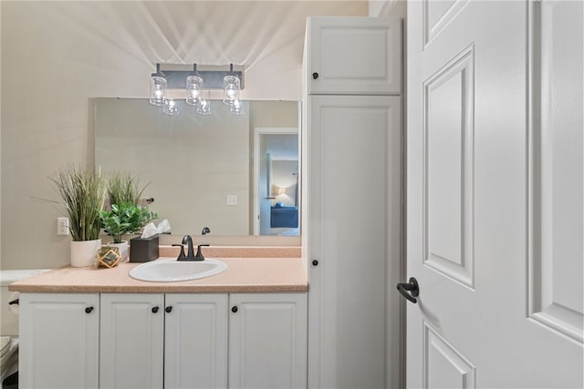 bathroom featuring toilet and vanity