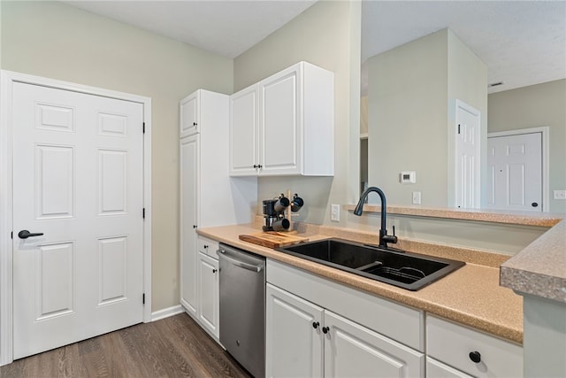 kitchen featuring dark hardwood / wood-style flooring, sink, white cabinetry, and stainless steel dishwasher