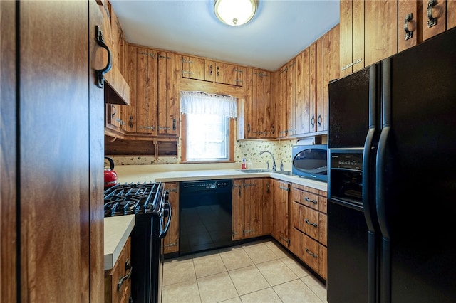 kitchen with black appliances, sink, light tile patterned flooring, wooden walls, and exhaust hood