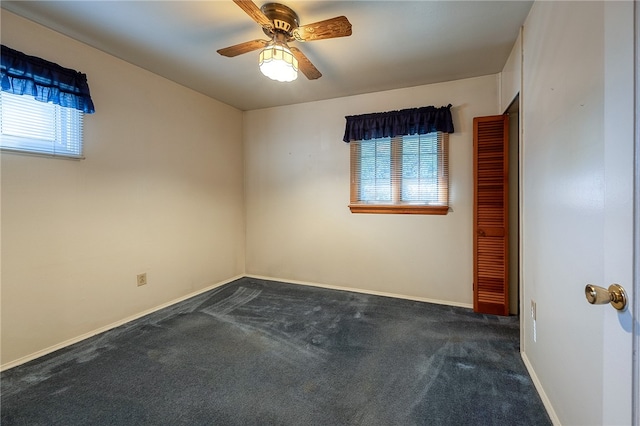 unfurnished room with ceiling fan, a healthy amount of sunlight, and carpet flooring