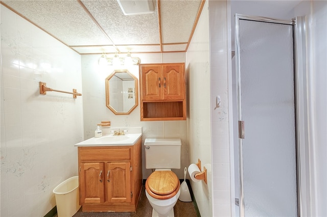 bathroom featuring a shower with door, toilet, and vanity