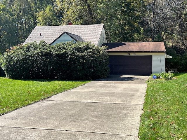 view of front of house with a front lawn and a garage