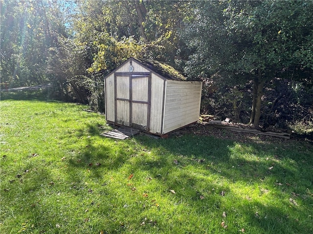 view of outbuilding with a lawn