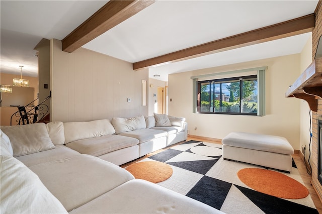 living room featuring a notable chandelier and beam ceiling