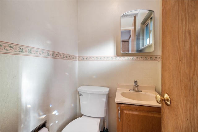 bathroom with toilet and vanity