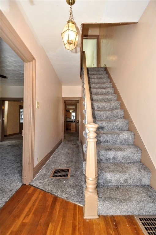 stairs with wood-type flooring