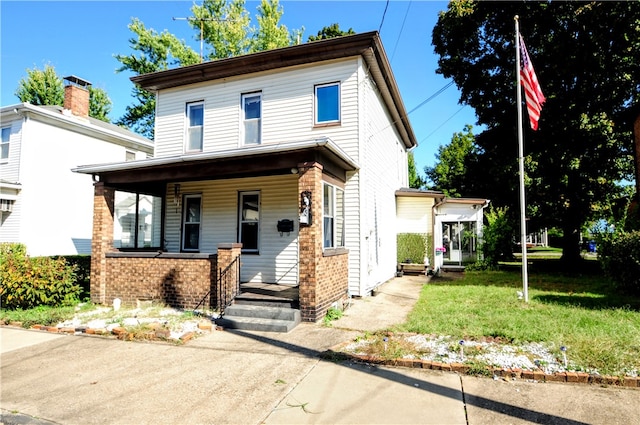 view of front of property with a porch and a front lawn