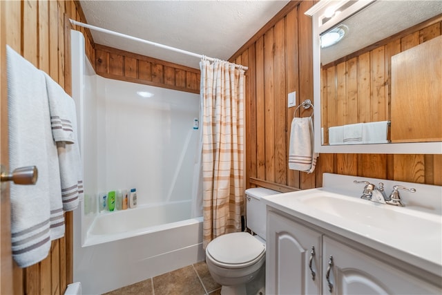 full bathroom featuring vanity, wood walls, shower / tub combo, tile patterned floors, and toilet