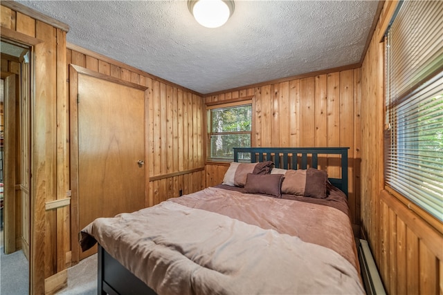 bedroom featuring wood walls and a textured ceiling