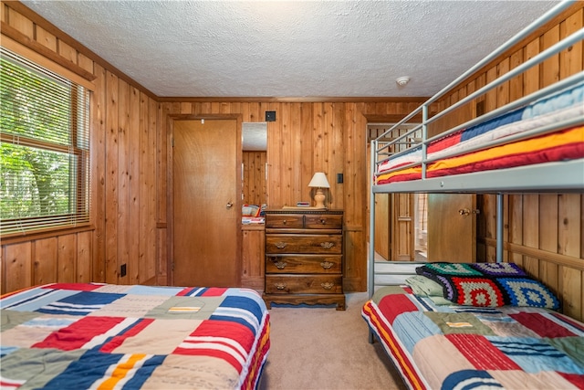 bedroom featuring carpet floors and wooden walls