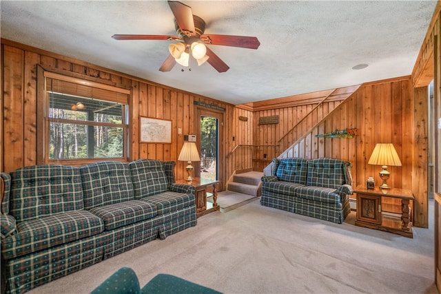 living room with wood walls, plenty of natural light, and a textured ceiling