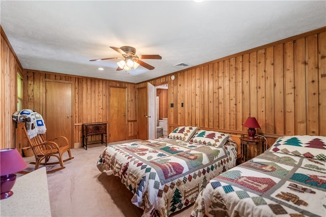 bedroom featuring wooden walls, ceiling fan, and crown molding