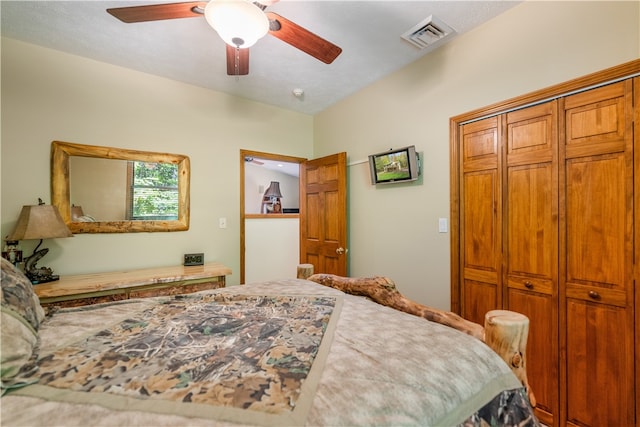 bedroom with ceiling fan, a closet, and a textured ceiling